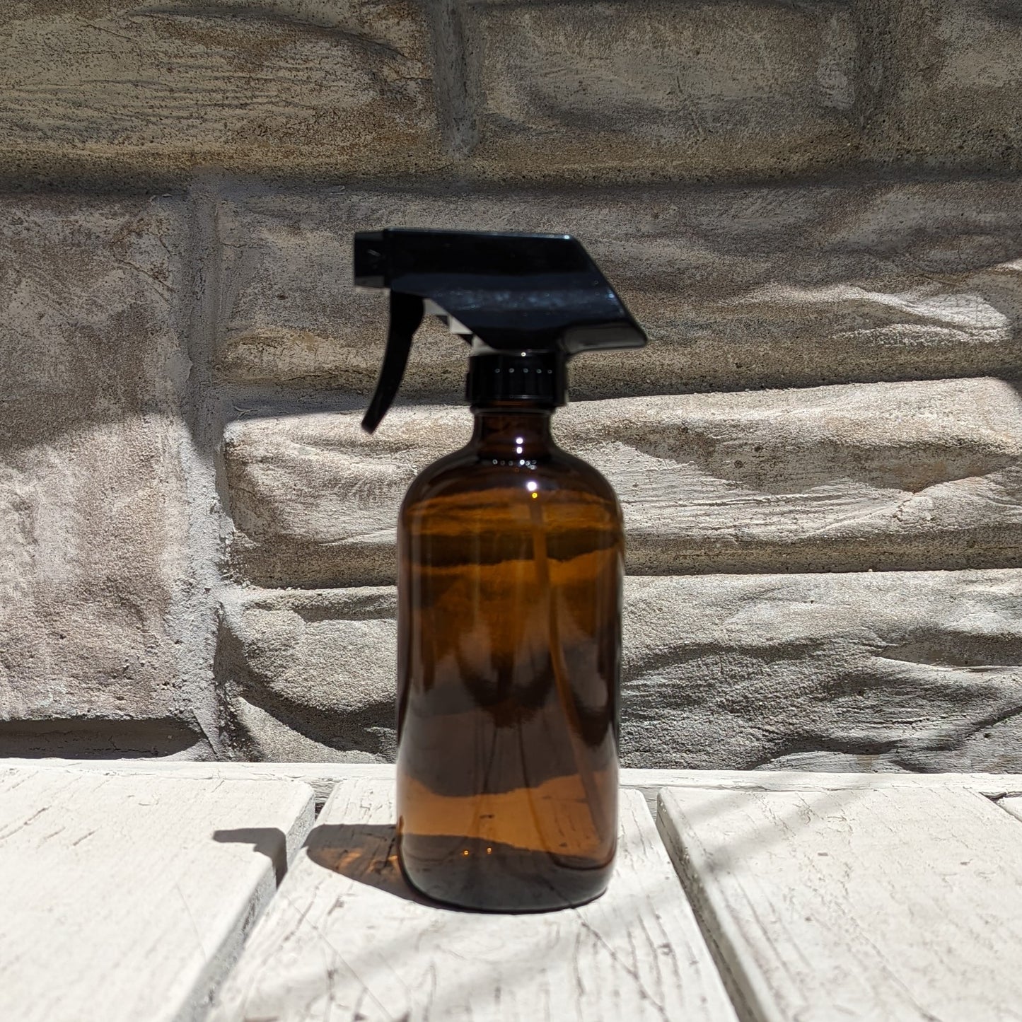 16 fl oz Amber Boston Round Bottle with Black Spray Nozzle